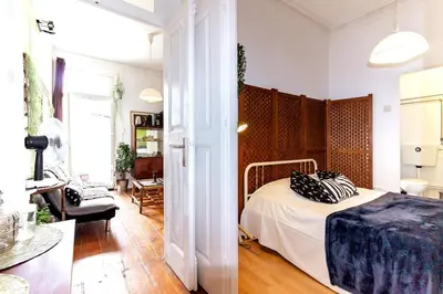 a bedroom with a bed and a living room at Ai Porto! Family 3 in Porto