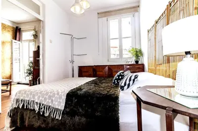 a bedroom with a bed and a table with a lamp at Ai Porto! Family 3 in Porto