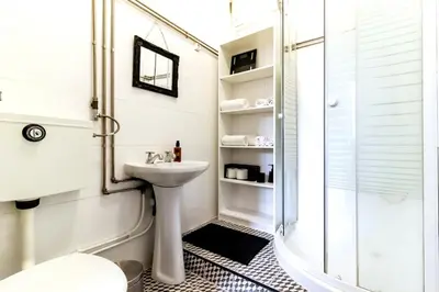 a white bathroom with a shower and a sink at Ai Porto! Family 3 in Porto