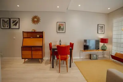 a hotel room with two beds and a window at Duque & Company Apartment by Vacationy in Porto