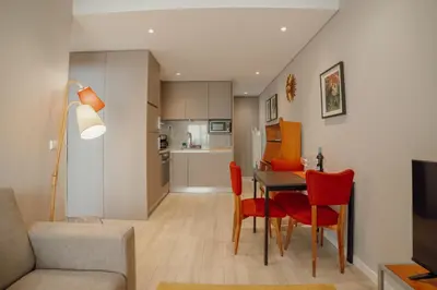 a white bathroom with a sink and a toilet at Duque & Company Apartment by Vacationy in Porto