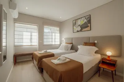 a living room with a table and chairs and a television at Duque & Company Apartment by Vacationy in Porto