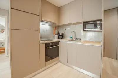 a hotel room with two beds and a mirror at Duque & Company Apartment by Vacationy in Porto