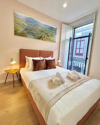 a bedroom with a large bed with a large window at Douro Views by MyMoradia in Porto