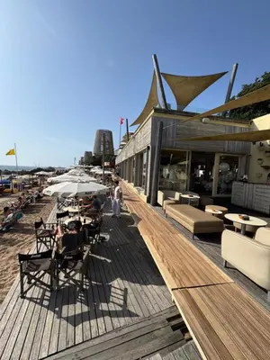 a wooden deck with tables and chairs on a beach at Douro Views by MyMoradia in Porto