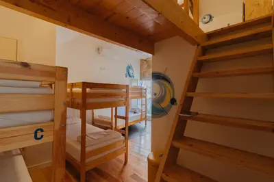 a room with several bunk beds in a house at Happy Porto Hostel in Porto