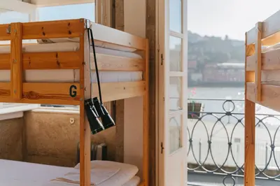 a room with a bunk bed and a balcony at Happy Porto Hostel in Porto