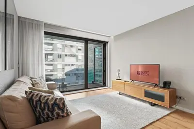 a living room with a couch and a flat screen tv at GuestReady – City Center Apartment with Balcony in Porto
