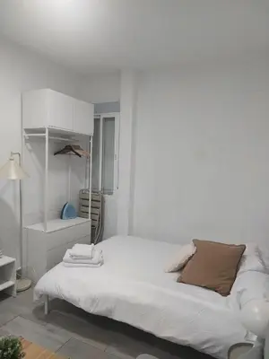 a white bed in a white room with a lamp at PTLC225 Apartament T1 Porto Centro in Porto