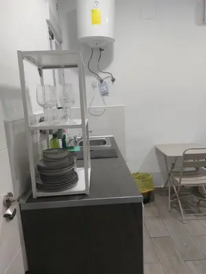 a kitchen with a counter with plates and glasses at PTLC225 Apartament T1 Porto Centro in Porto
