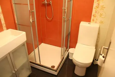 a bathroom with a shower and a toilet and a sink at Pinho Apartments, Studios and Rooms in Porto