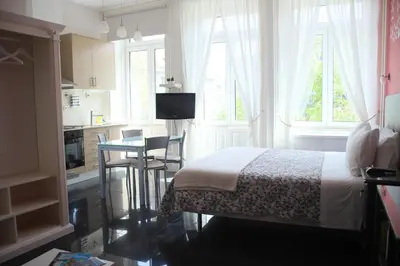 a kitchen and a bedroom with a bed and a table at Pinho Apartments, Studios and Rooms in Porto