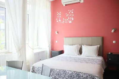 a red bedroom with a bed and a glass table at Pinho Apartments, Studios and Rooms in Porto