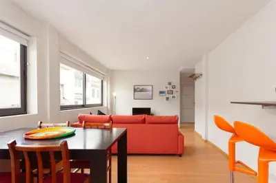 a living room with a red couch and a table at Picaria Apartment in Porto