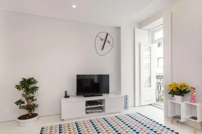 a white living room with a flat screen tv at PortoWhite city lofts in Porto
