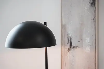 a black lamp sitting next to a wall at Stylish Retreat in Central Porto Stay with Parking in Porto