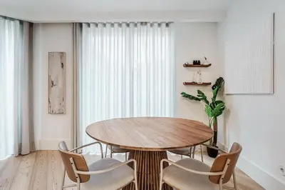 a dining room with a wooden table and chairs at Stylish Retreat in Central Porto Stay with Parking in Porto