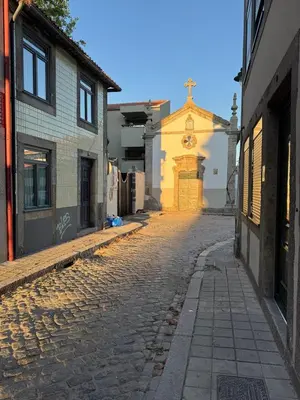 an empty street with a church in the background at Water VibesI City Views in Porto by MyMoradia in Porto