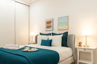 a bedroom with a large bed with a blue blanket at Open-Plan Apartment in Downtown Porto by HostWise in Porto