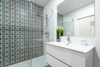 a bathroom with a white sink and a shower at Open-Plan Apartment in Downtown Porto by HostWise in Porto