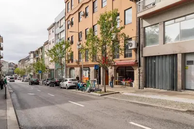 a city street with cars parked on the side of the road at Open-Plan Apartment in Downtown Porto by HostWise in Porto