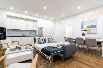 a living room with a bed and a kitchen at Open-Plan Apartment in Downtown Porto by HostWise in Porto
