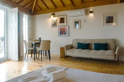 a living room with a couch and a table at Belas Artes Apartments in Porto