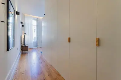 a hallway with white walls and a hard wood floor at ApartmentsPorto - Alexandre Braga in Porto