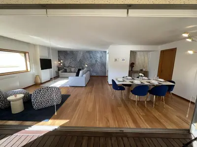 a dining room and living room with a table and chairs at Ouro Views to Douro River in Porto