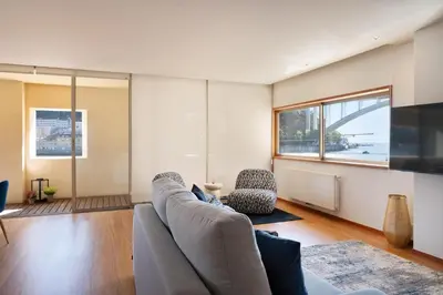 a living room with a couch and a television at Ouro Views to Douro River in Porto