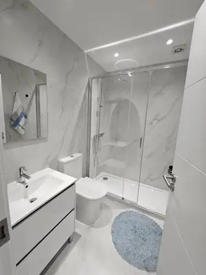 a bedroom with two beds and a table and a door at Boavista Family T3 in Porto