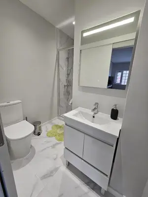 a white bathroom with a sink and a toilet at Boavista Family T3 in Porto