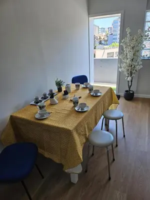 a kitchen and a living room with a table and a mirror at Boavista Family T3 in Porto
