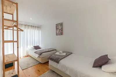 a bedroom with a blue bed with towels on it at Urban Terrace Porto in Porto