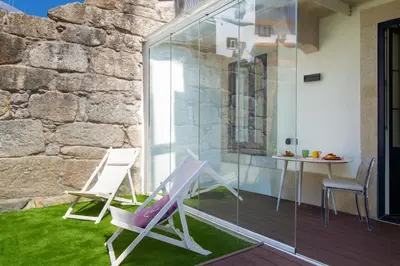 a patio with two chairs and a table at Santa Catarina Studio w Patio by LovelyStay in Porto