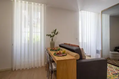 a living room with a table and a couch at Santa Catarina Studio w Patio by LovelyStay in Porto
