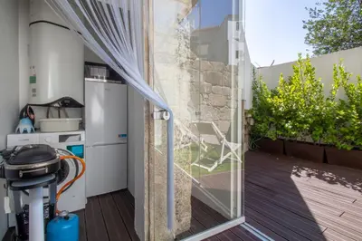 a glass door leading into a kitchen with a patio at Santa Catarina Studio w Patio by LovelyStay in Porto