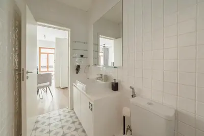 a white bathroom with a sink and a toilet at Downtown Comfort Apartment by Vacationy in Porto