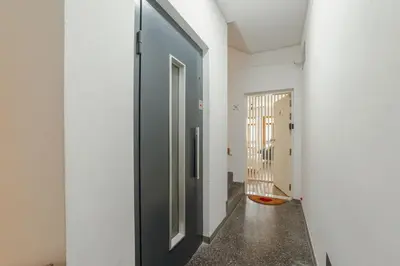a hallway with a black door in a white wall at Downtown Comfort Apartment by Vacationy in Porto
