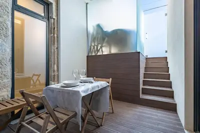 a bathroom with a shower and a toilet and towels at Castelões Tiles Studio With Terrace in Porto