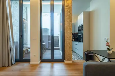 a bathroom with a sink and a toilet and a mirror at Castelões Tiles Studio With Terrace in Porto