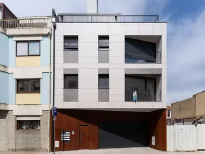 a person standing on the balcony of a building at Gaia Bella Guest House in Vila Nova de Gaia