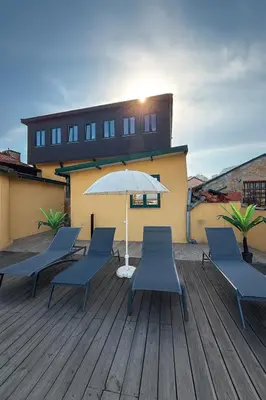 a patio with chairs and an umbrella on a deck at Douro Villa 13 - Best View in Town in Vila Nova de Gaia