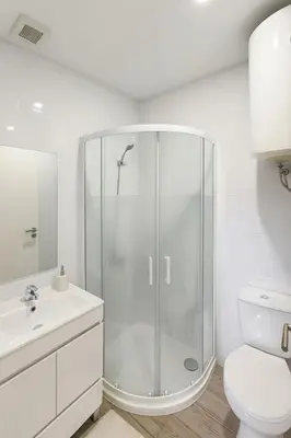 a white bathroom with a shower and a toilet at Douro Villa 13 - Best View in Town in Vila Nova de Gaia