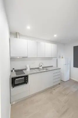 a white kitchen with white cabinets and a sink at Douro Villa 13 - Best View in Town in Vila Nova de Gaia