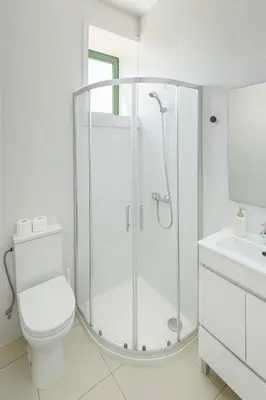 a white bathroom with a shower and a toilet at Douro Vila 10 - Best View in Town in Bandeira