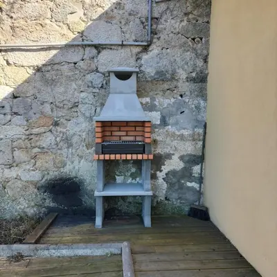 a small stool sitting next to a brick wall at Douro Vila 10 - Best View in Town in Bandeira