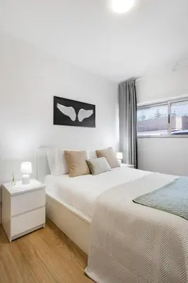 a living room with a couch and a flat screen tv at Smart Stay in Gaia | Cozy & Work-Ready in Vila Nova de Gaia