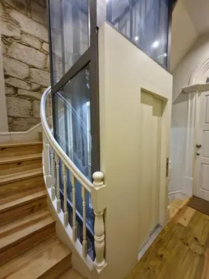 a spiral staircase in a home with a stone wall at Alma Porto in Porto