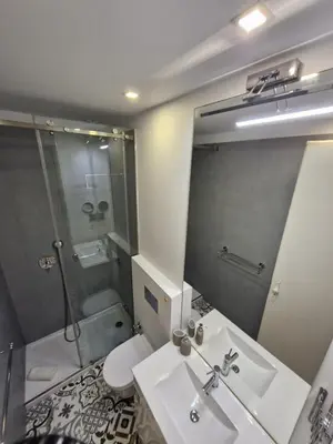 a bathroom with a sink and a shower and a toilet at Alma Porto in Porto